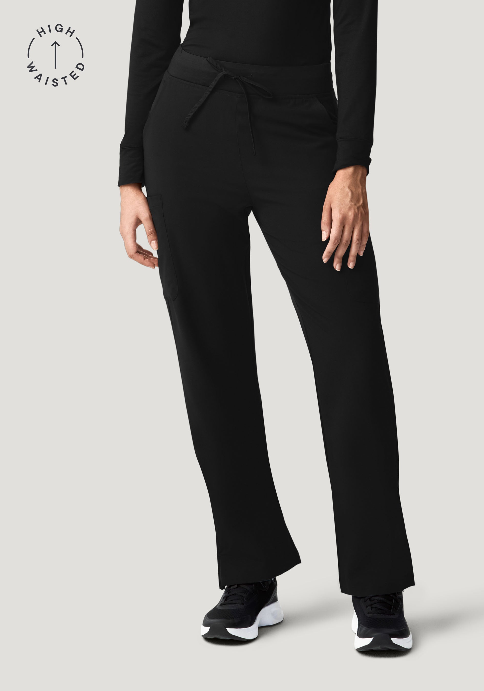 Black high-waisted pants worn by a person on a light gray background